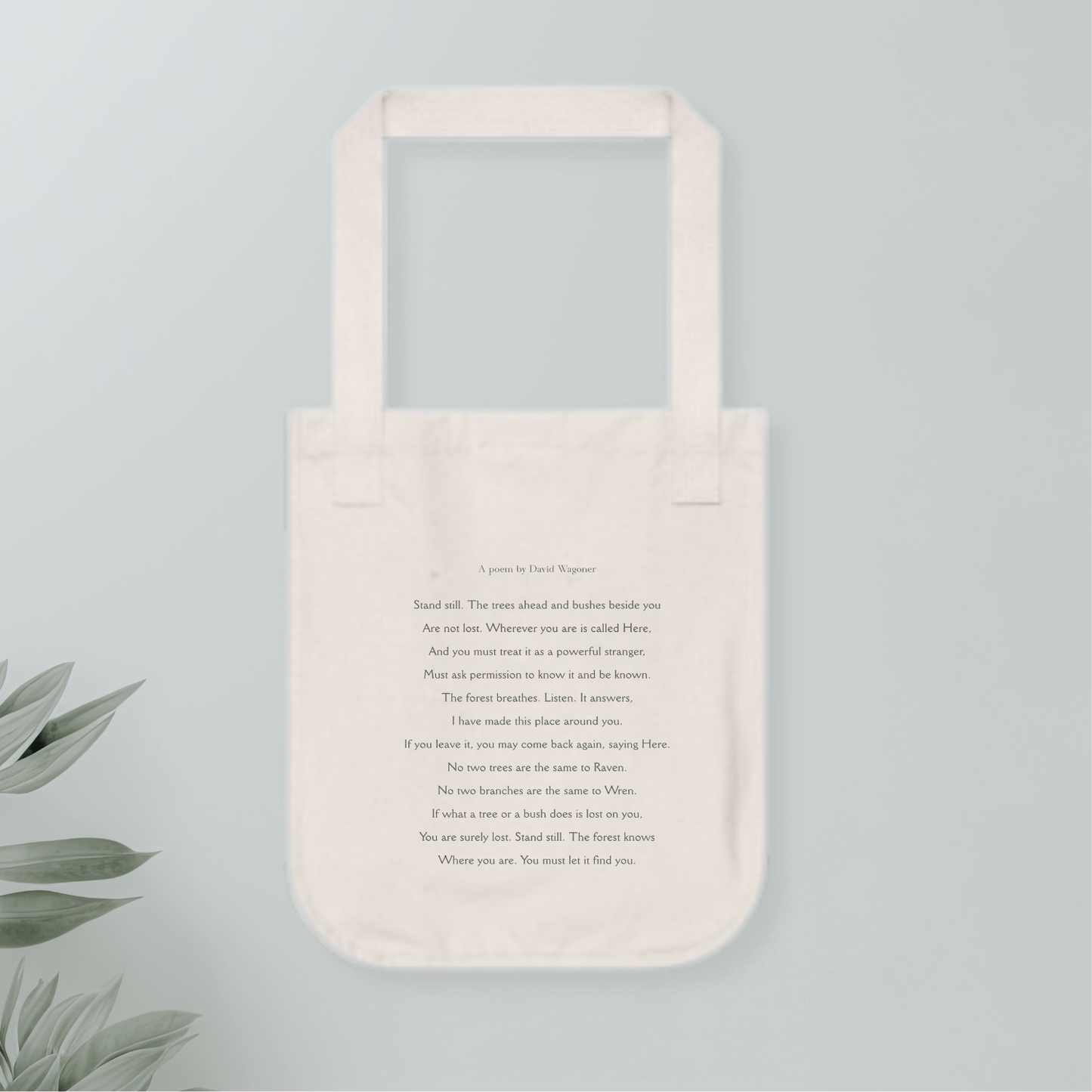 Beige tote bag with text or poem on a light gray background