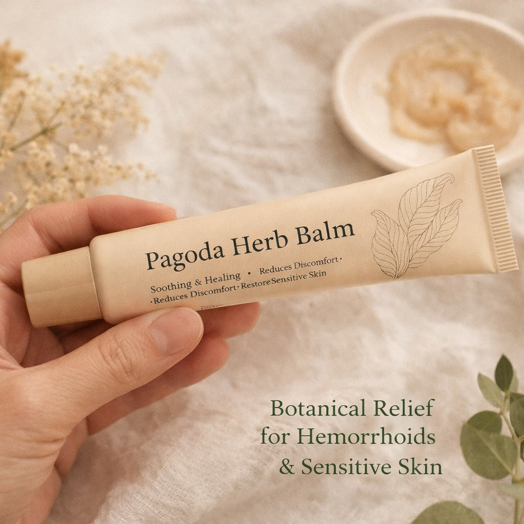 Hand holding a tube of Pagoda Herb Balm with text about its benefits on a soft background.