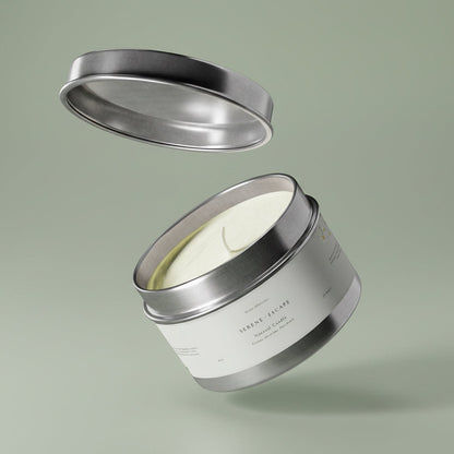 Silver candle jar with lid on a light green background