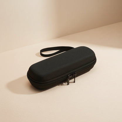 Black hard-shell travel case with a handle on a beige background