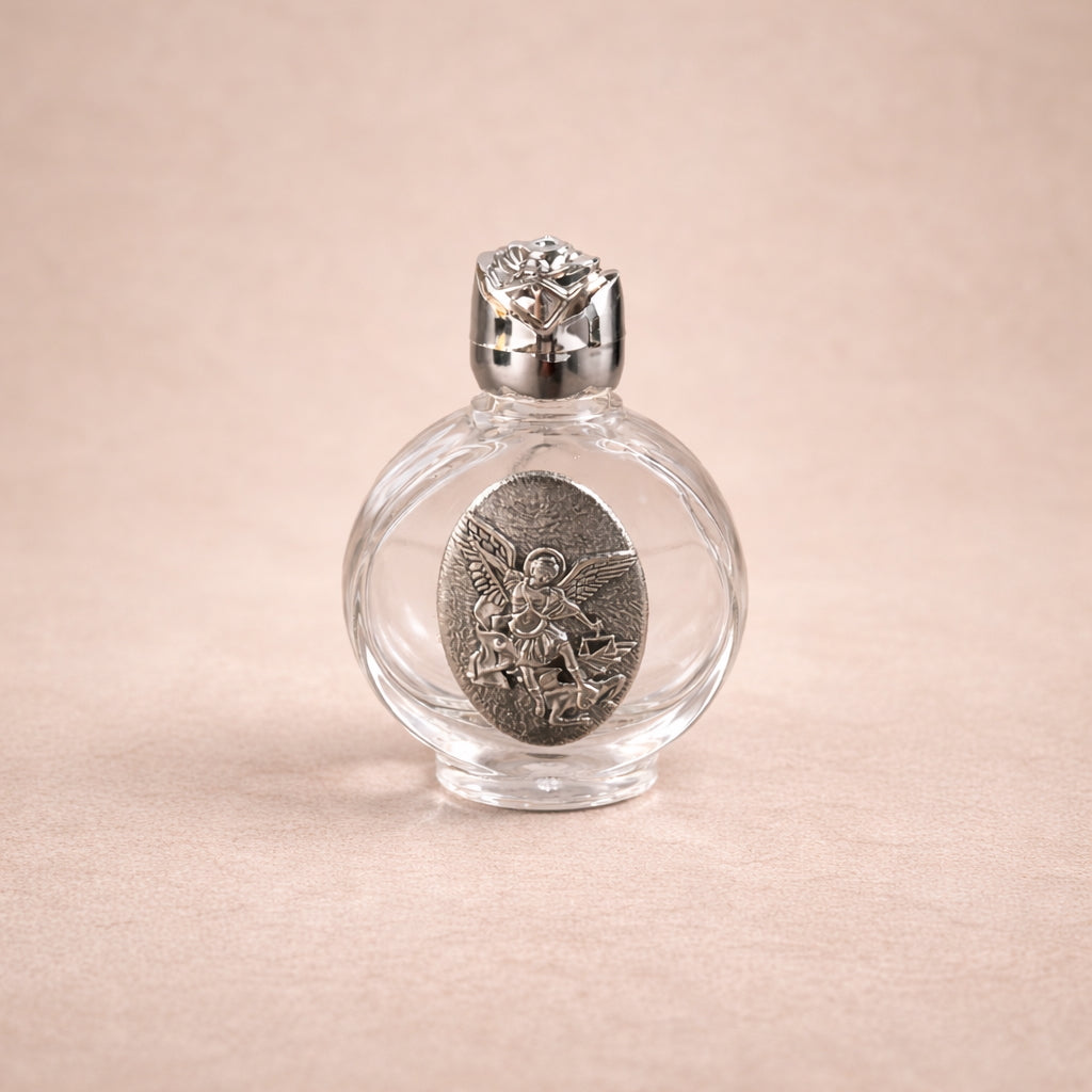 Clear glass bottle with silver cap and decorative label on a beige background