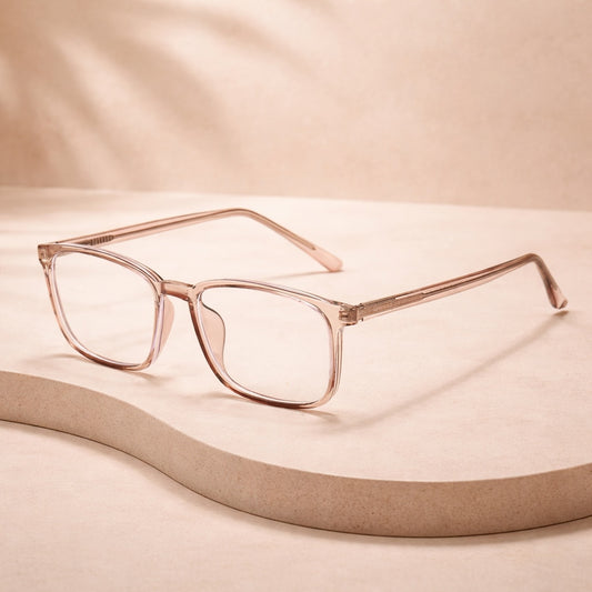 tea eyeglasses on a beige surface with a soft focus background