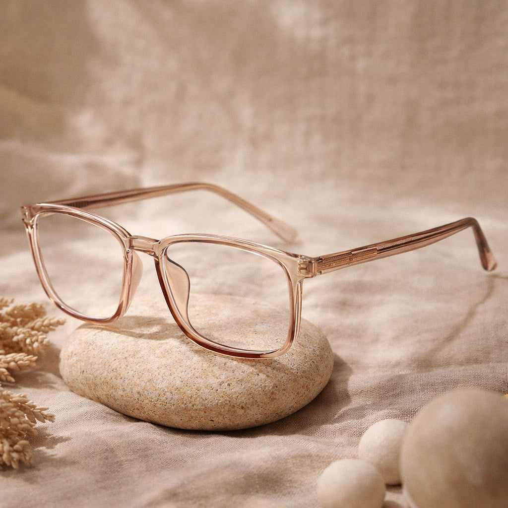 Rose gold glasses on a stone with a soft beige background